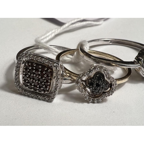 775A - 2 9ct hallmarked gold rings set pave style black and clear diamonds, the centre of each swivelling t... 