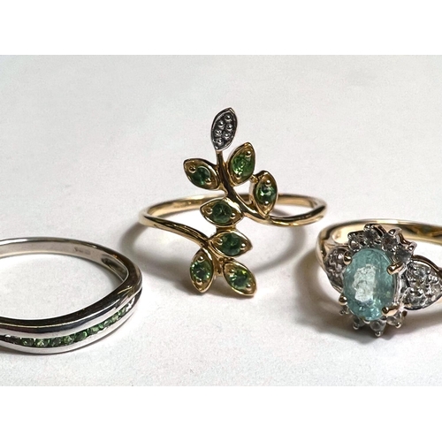 777 - A 9ct hallmarked gold ring with green stones in leaf like setting, possibly emerald, size P; a 9ct h... 