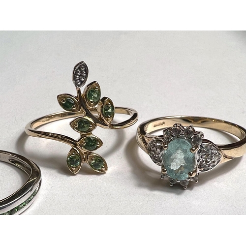 777 - A 9ct hallmarked gold ring with green stones in leaf like setting, possibly emerald, size P; a 9ct h... 