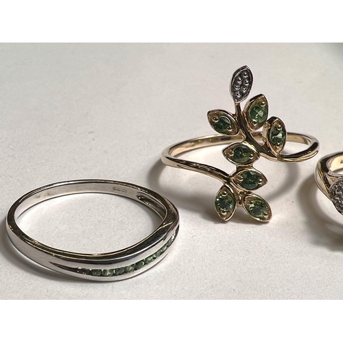 777 - A 9ct hallmarked gold ring with green stones in leaf like setting, possibly emerald, size P; a 9ct h... 