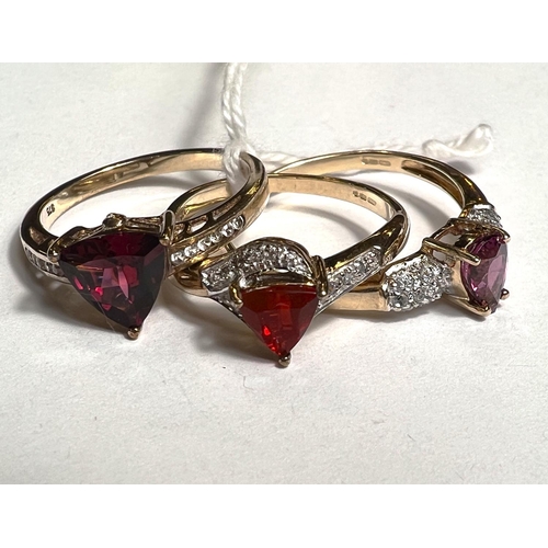 777A - Two 9ct hallmarked gold rings each set with a single red/purple stone; another 9ct hallmarked gold r... 