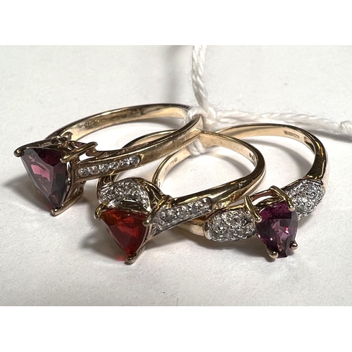 777A - Two 9ct hallmarked gold rings each set with a single red/purple stone; another 9ct hallmarked gold r... 