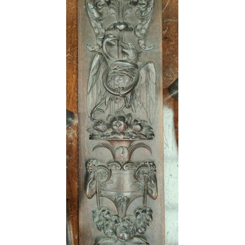 112A - A 19th century carved wooden wall hanging plaque with relief decoration of various heads, cornucopia... 