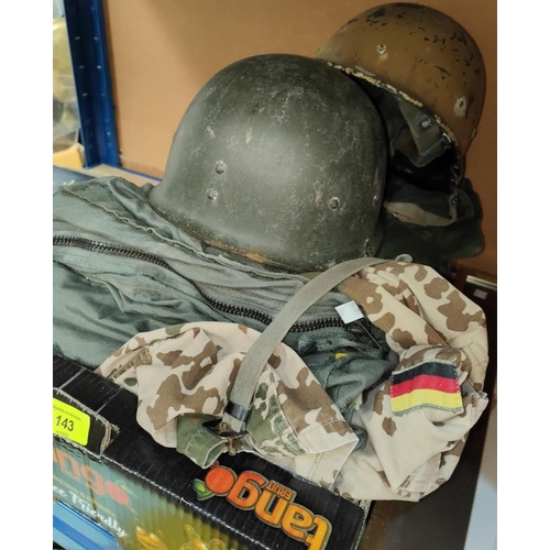 143 - An M1 WWII style American composition helmet with strapping inside, a large green military style ove... 