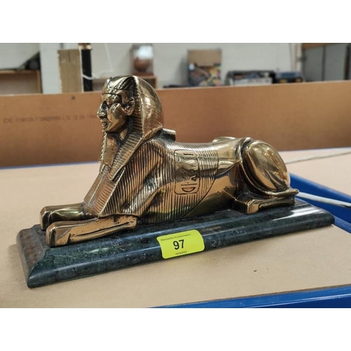 97 - A cast brass Egyptian sphinx on green marble base, overall length 28cm