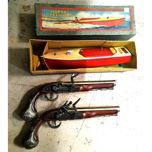 253 - A Hornby Speedboat in original box; a pair of reproduction pistols