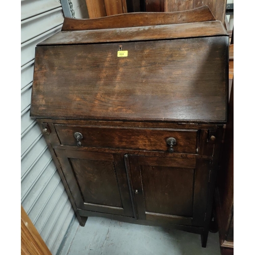 824 - A 1930's oak bureau with cabinet under;  a carved oak side cabinet; a small oak effect chest.