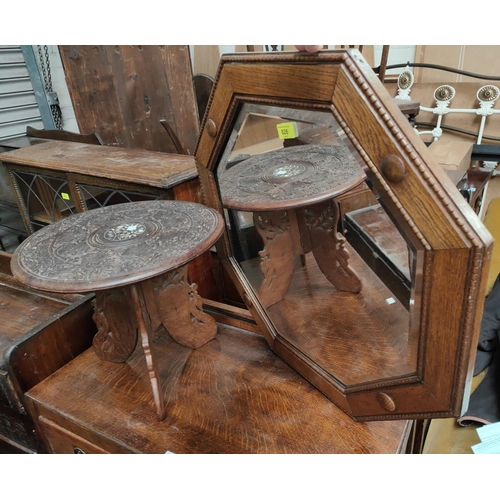 826 - An octagonal headed oak wall mirror; a small carved oriental occasional table.