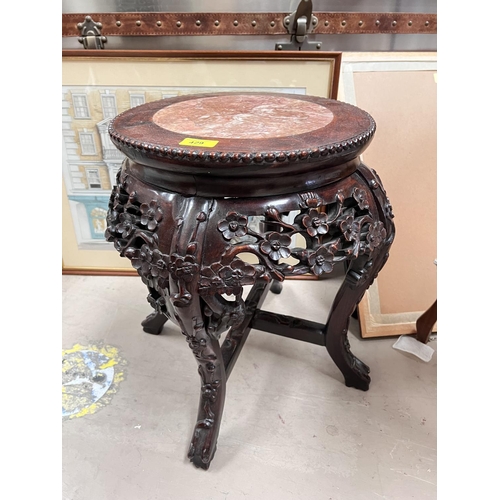 429 - A Chinese carved and pierced wooden occasional table/ vase stand, with central marble piece floral d... 