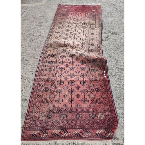 1000 - A rust ground mid 20th century hand knotted Bokhara runner