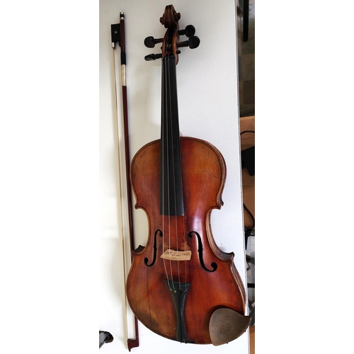 205B - A late 19th early 20th century full size violin two piece back violin stamped and labelled to the in... 