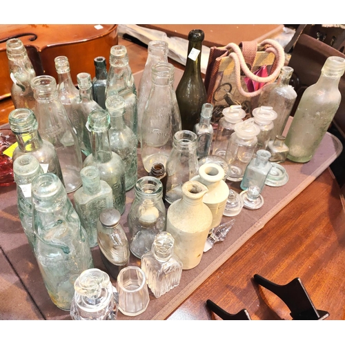 574 - A selection of cranberry glass; old glass bottles; etc.