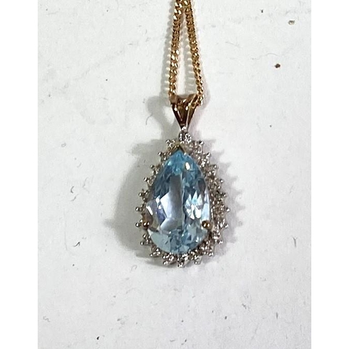 619 - An 9ct hallmarked gold pendant set with a teardrop shaped aquamarine coloured stone surrounded by sm... 