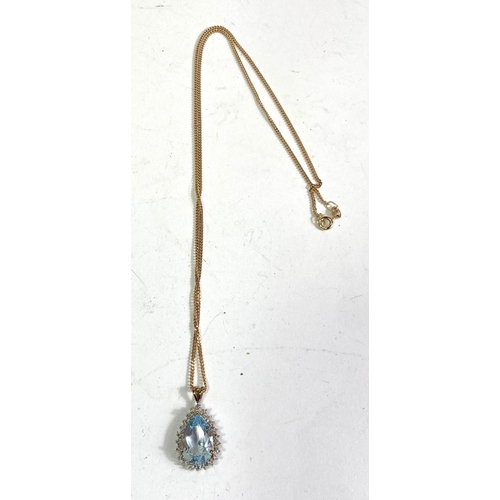 619 - An 9ct hallmarked gold pendant set with a teardrop shaped aquamarine coloured stone surrounded by sm... 