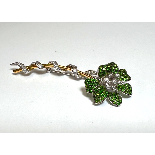 736 - A GREEN (Demantoid) GARNET and a diamond floral brooch set in white and yellow gold, stamped 750, gr...