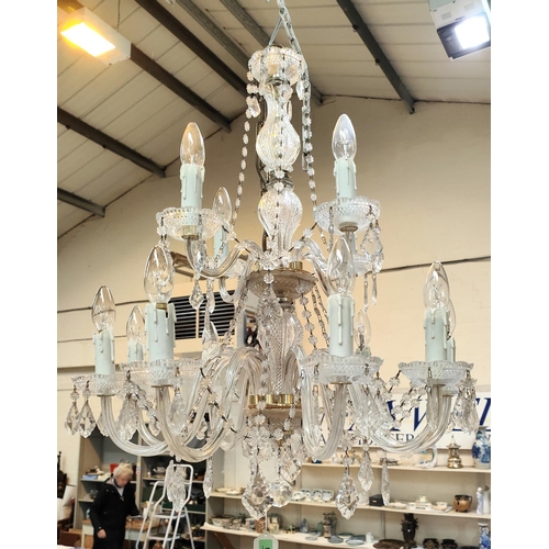 1059 - A Victorian style 12 branch 2 tier glass chandelier with cut and faceted drops