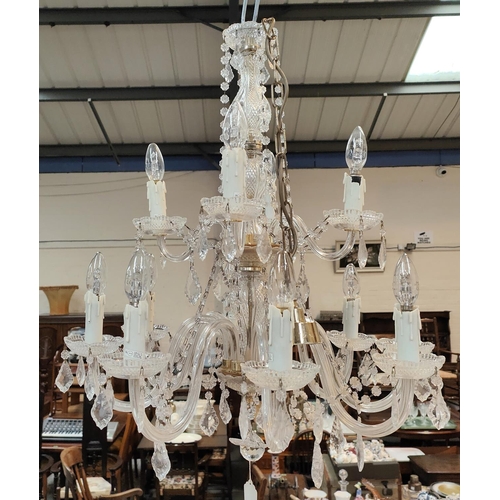 1059 - A Victorian style 12 branch 2 tier glass chandelier with cut and faceted drops