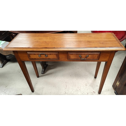 1064 - A Reproduction Regency light wood crossbanded and distressed side/ serving table, with two drawers