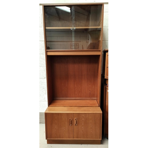 1065 - A mid 20th century G-plan style wall unit with shelves above and cupboard bellow