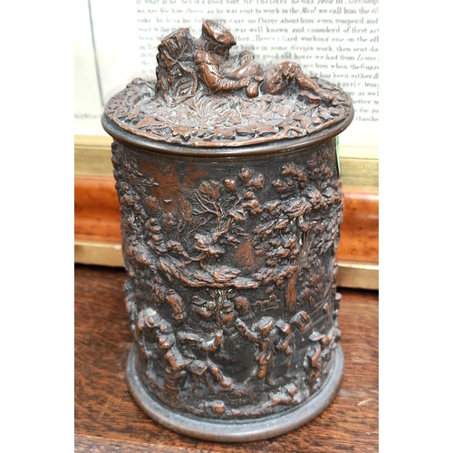 174 - A 19th century Dutch copper tobacco jar with high relief decoration of genre scenes, 17cm