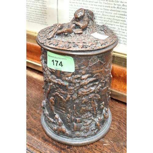 174 - A 19th century Dutch copper tobacco jar with high relief decoration of genre scenes, 17cm