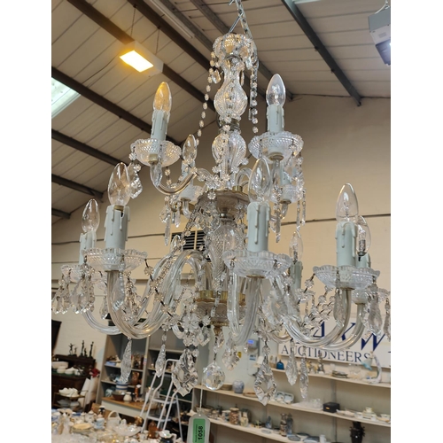 1058 - A Victorian style 12 branch 2 tier glass chandelier with cut and faceted drops