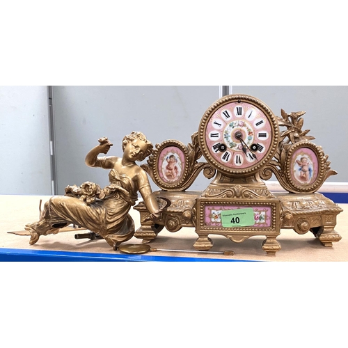 40 - A 19th century gilt metal and pink ground Sevres style porcelain mantle clock surmounted by a woman ... 