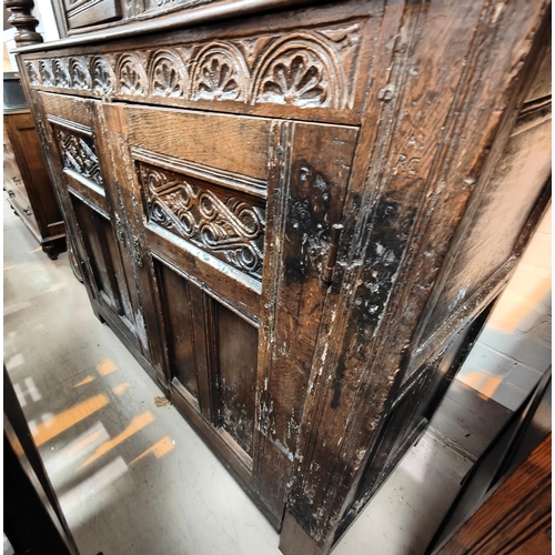 1056 - A late 17th/early 18th century Deudarn with extensive carved decoration, the upper section with twin... 