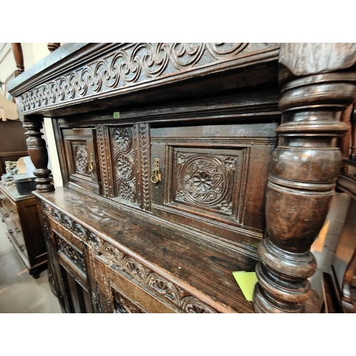 1056 - A late 17th/early 18th century Deudarn with extensive carved decoration, the upper section with twin... 