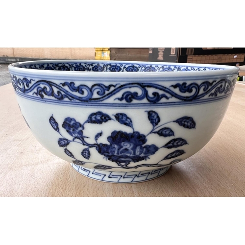 416 - A Chinese blue and white bowl decorated with flowers and fruits etc with six character mark to base,... 