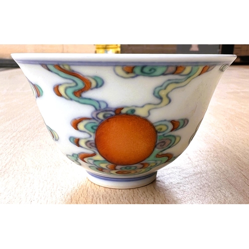 412 - A Chinese tea bowl with polychrome decoration and six character mark to base, diameter 7.5cm