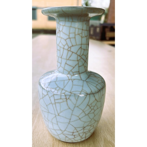 428 - A Chinese pale green crackle glazed vase with flared rim, height 18cm