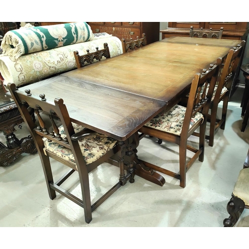 899 - An Ercol style dining suite in the Jacobean manner with draw leaf table and 6 (4 + 2) chairs with ar... 