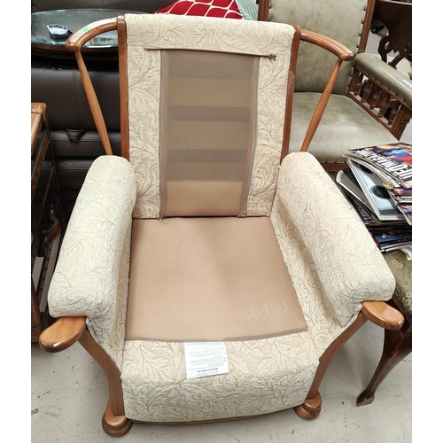 897 - An Ercol style armchair with light wood frame