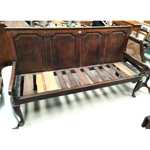 894 - An 18th century Country made oak settle with 3 arched and fielded panels to the back, slatted seat a... 