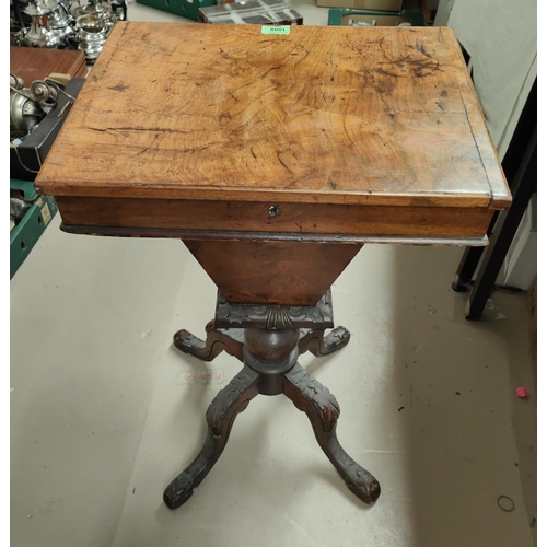 882 - A rectangular walnut work table with hinged lid and fitted interior tapering well & 4 carved scr... 