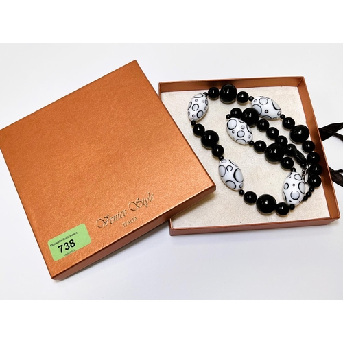 716 - VENICE STYLE, a glass bead necklace in black and white with silver clasp, 64cm; a polished bead neck... 