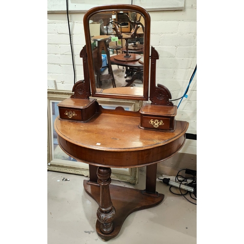 876 - A Victorian mahogany demi-lune dressing table with 2 jewellery drawers and under tier, on turned fro... 