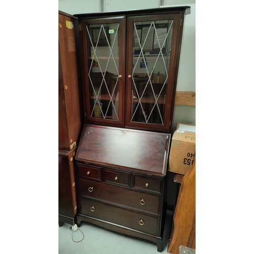 906 - A Stag display bureau bookcase with double glazed doors above, fall front with fitted interior three... 