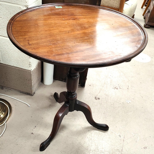 843 - A Georgian Mahogany tilt top tripod occasional table with circular top with raised rim lip, diameter... 