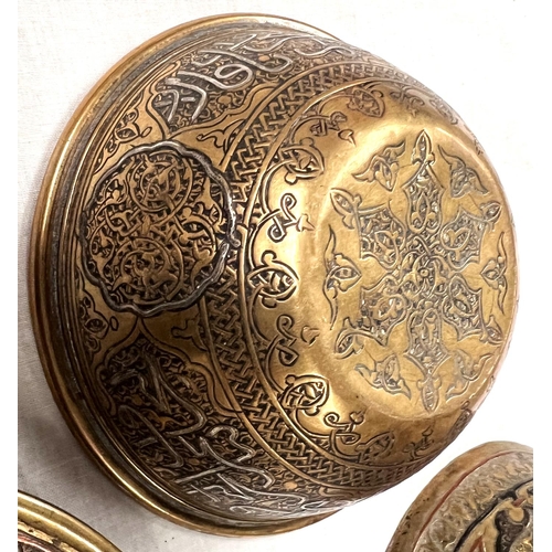 392B - An Islamic brass dish with silver and copper inlay, an Islamic coffee pot with similar inlay and bow... 