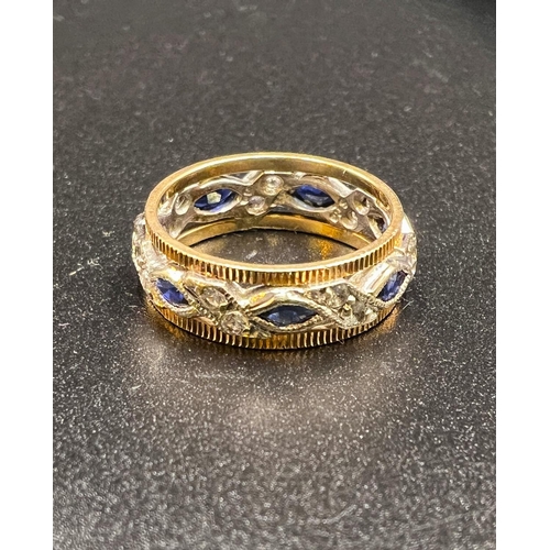 732 - A two tone yellow and white metal dress ring set with blue and white sapphires, 3.6gms, size K