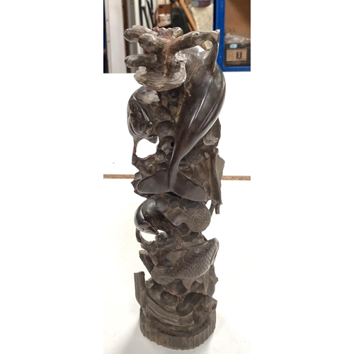 14 - A unusual hardwood carved totem of dolphins and fishes swimming around a reef, and a small musical p... 