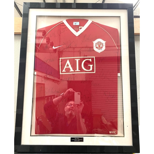 27 - A framed and glazed MUFC shirt, signed 