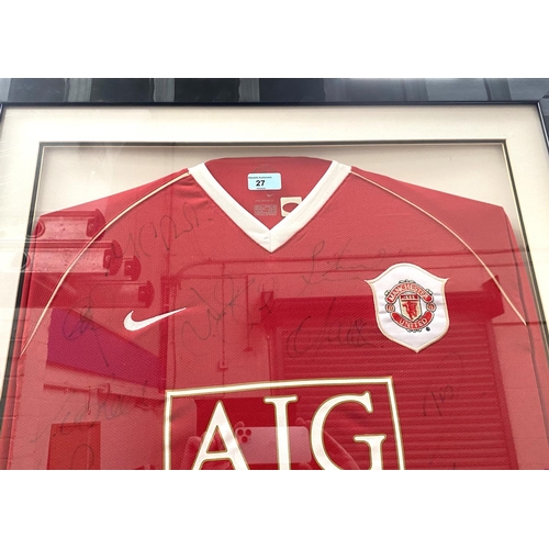 27 - A framed and glazed MUFC shirt, signed 