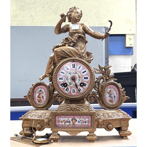 28 - A 19th century gilt metal and pink ground Sevres style porcelain mantle clock surmounted by a woman ... 