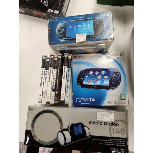 299 - A Sony PlayStation Portable boxed with a selection of games and a docking station, and a boxed PS Vi... 