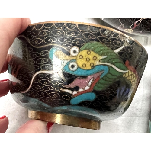 391A - A Chinese cloisonne black ground bowl decorated with dragons and a similar cup