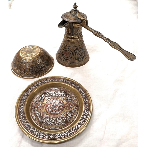 392B - An Islamic brass dish with silver and copper inlay, an Islamic coffee pot with similar inlay and bow... 