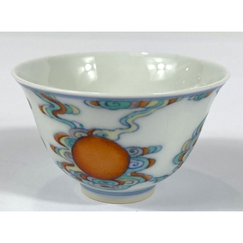 412 - A Chinese tea bowl with polychrome decoration and six character mark to base, diameter 7.5cm